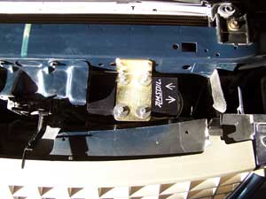 mounted against the radiator support bracket.